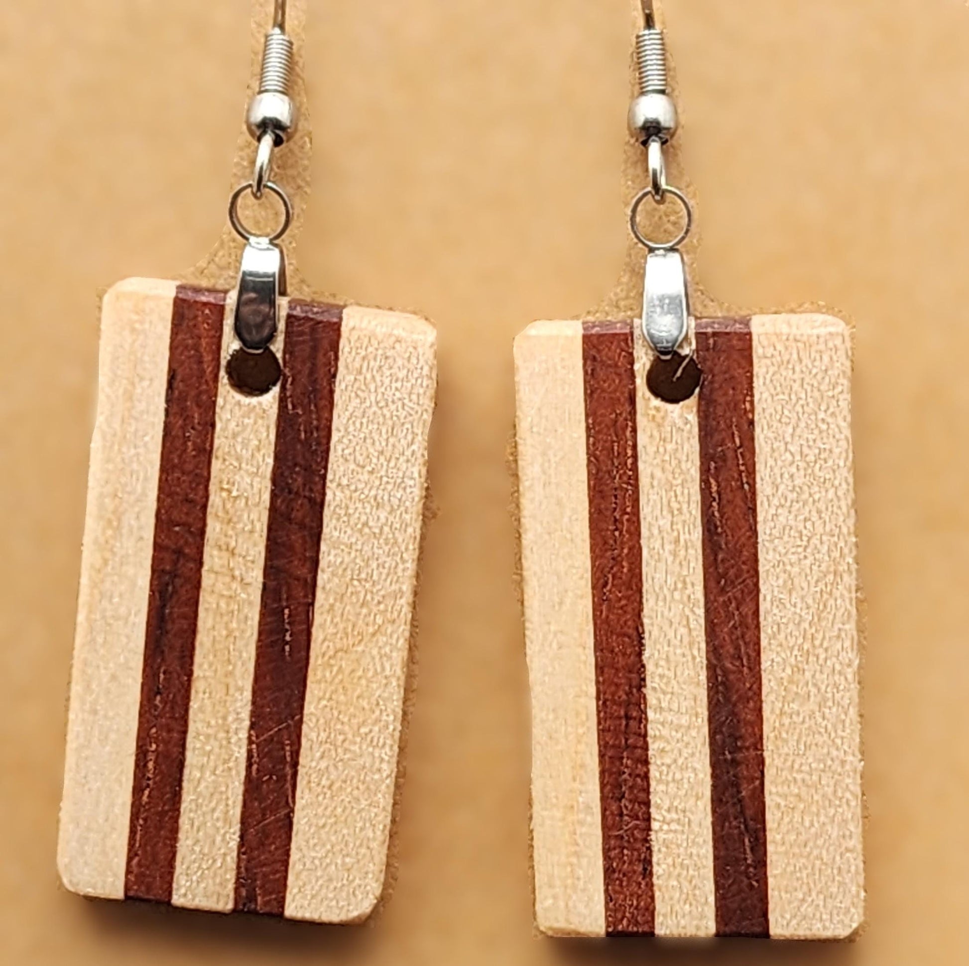 Strata Line earrings featuring vertical stripes in mixed wood tones. Artisan-crafted with clean, modern lines.

Black ribbon gift box for wooden earrings, available as a $3 add-on. Perfect for birthdays, weddings, and special occasions.