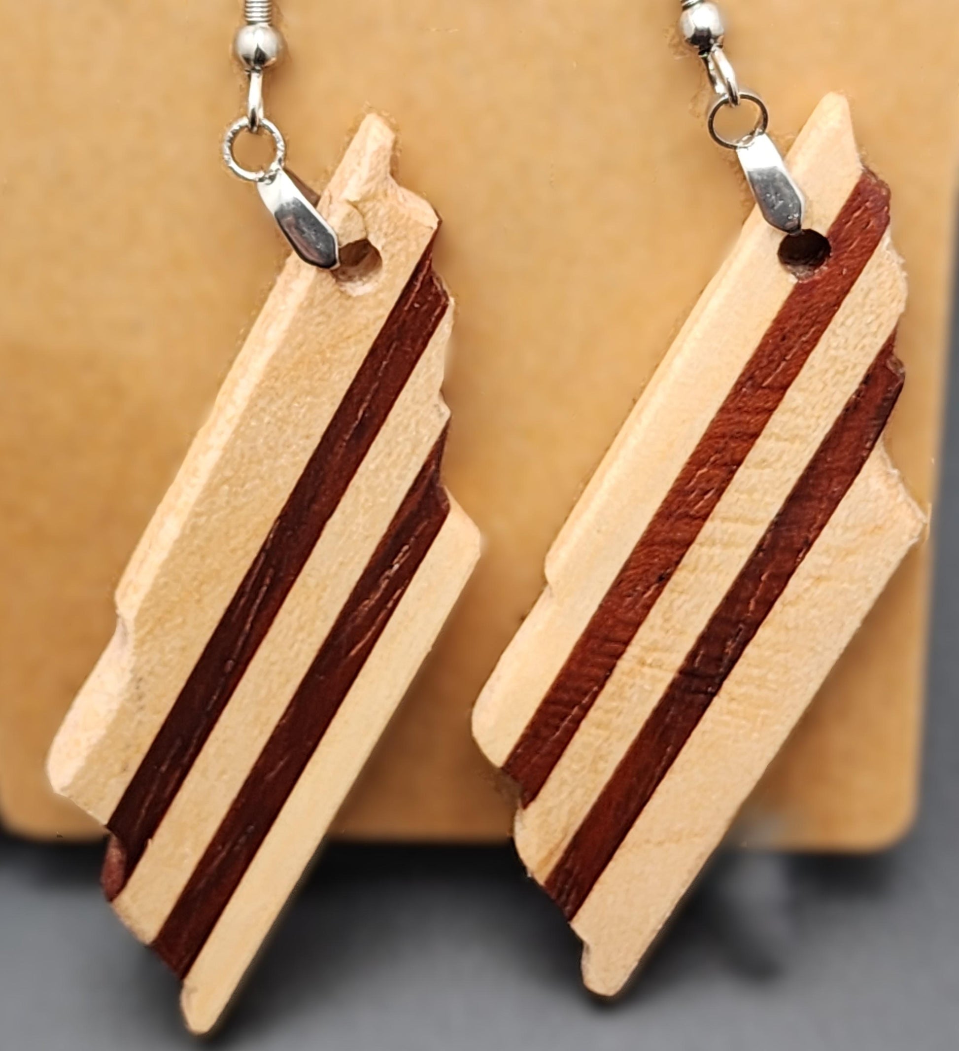 Brazilian Cherry Cut earrings with striped pattern in warm cherry wood. Artisan-made and lightweight.

Black ribbon gift box for wooden earrings, available as a $3 add-on. Perfect for birthdays, weddings, and special occasions.