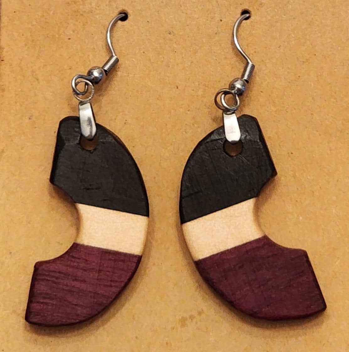 Triclipse circular earrings in contrasting wood tones. Handcrafted with smooth finish and bold design.

Black ribbon gift box for wooden earrings, available as a $3 add-on. Perfect for birthdays, weddings, and special occasions.